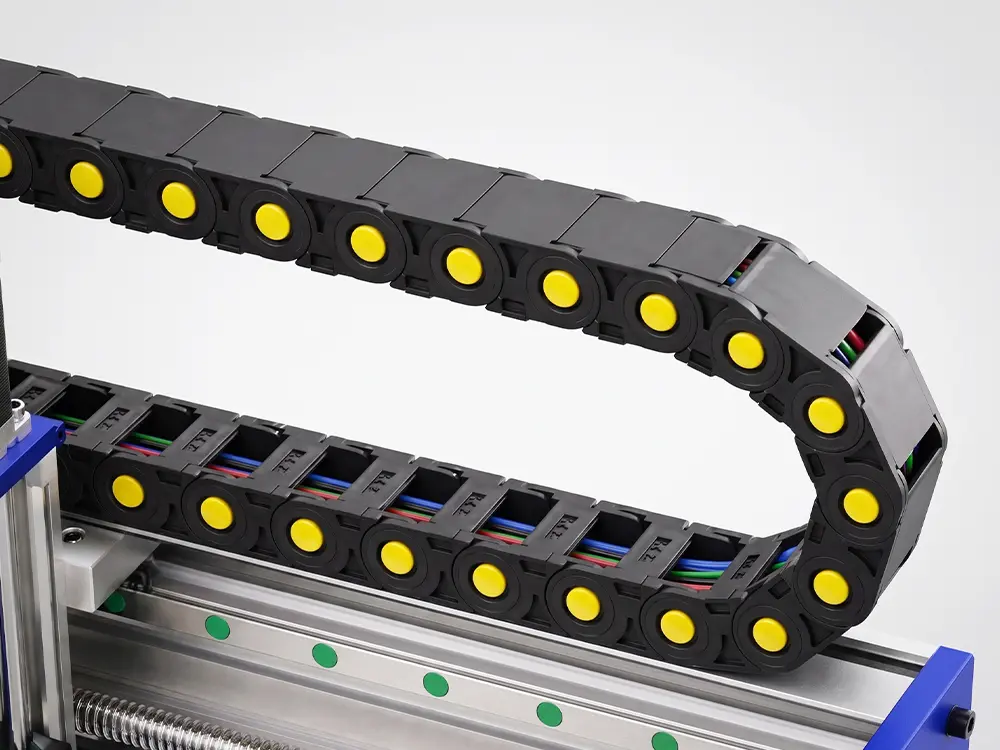 CNC Router Drag Chain Cable Management System Drag chain cable management system on the CNC Router, designed to organize cables and coolant hoses while protecting them from bending, wear, and damage during continuous machine operation.