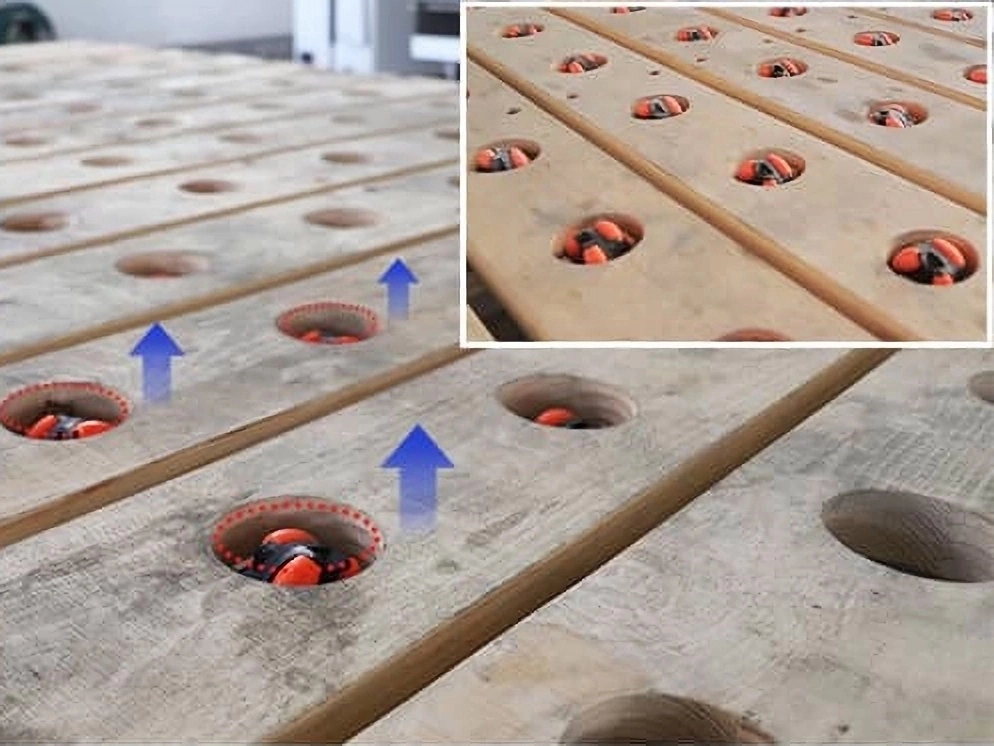 The universal wheels on the workbench can be raised and lowered to roll the stone plates above the workbench