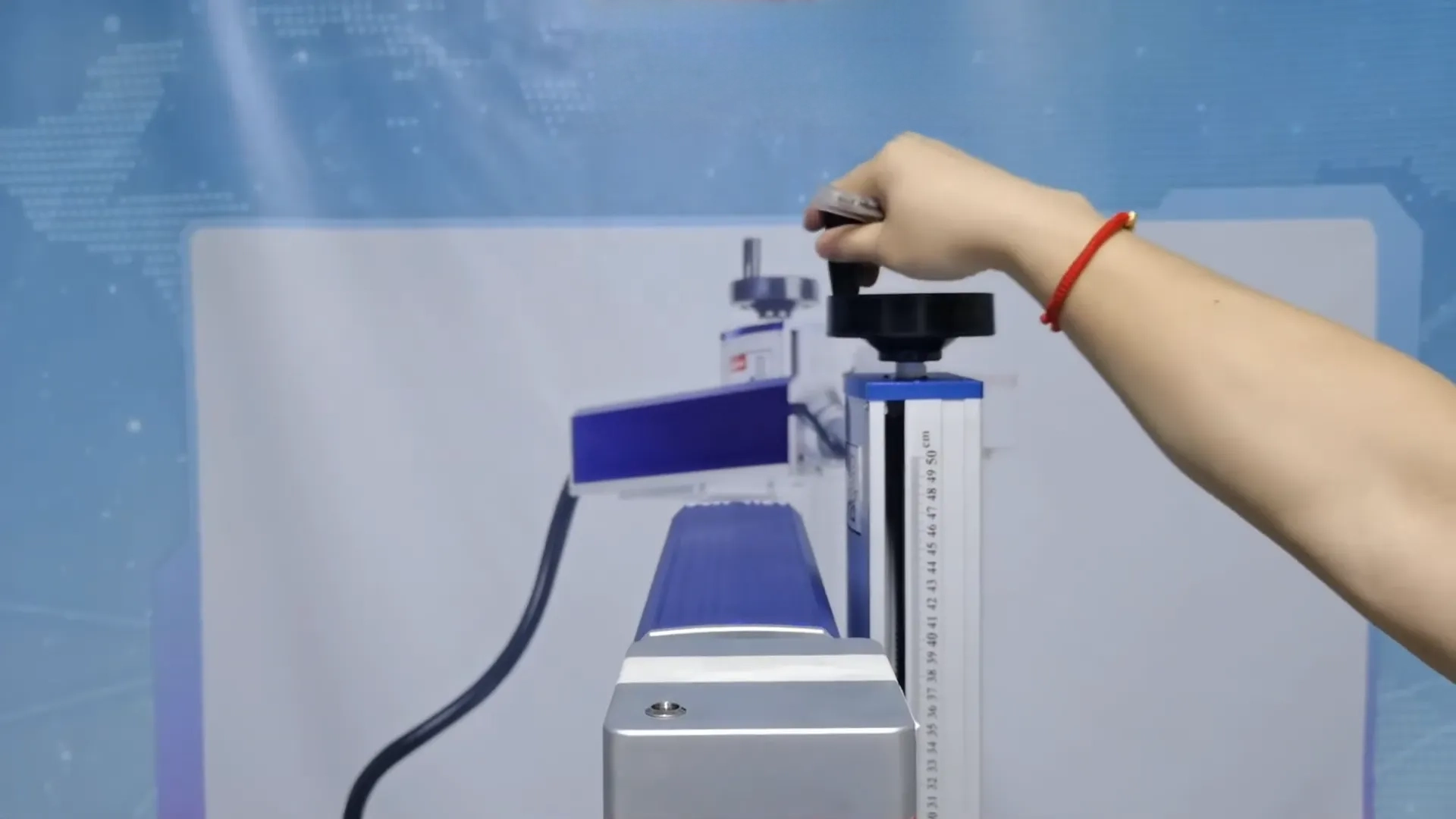 Turn the crank by hand to raise or lower the laser head to adjust the focal length